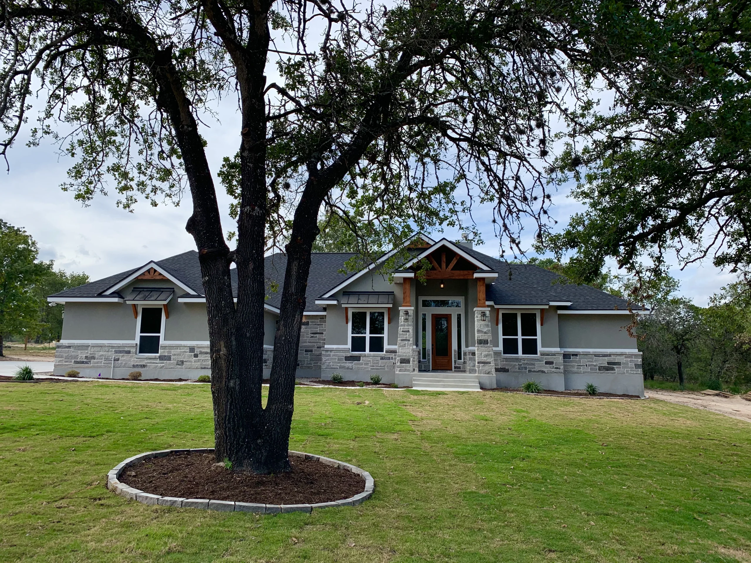 F&S custom home at dusk — build on your land